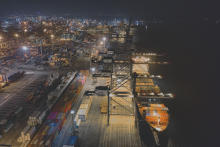Spotlight UNCTAD - dock with trade containers and boat - darkened